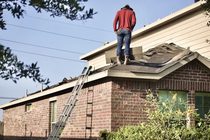 Professional roofer working on a residential roof in Thompson Place